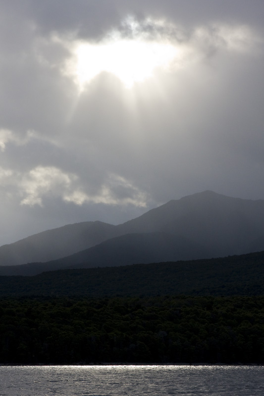 Sun Breaking Through Clouds Above Kepler Range And Lake Te Anau